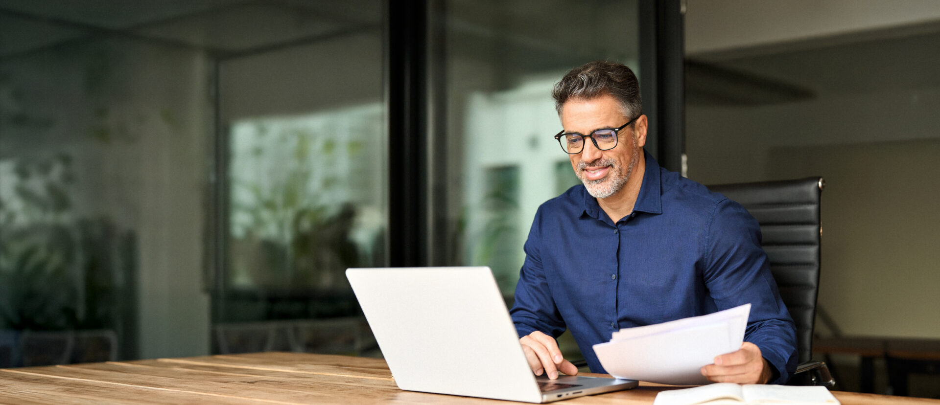 a man on his computer reviewing the options for a 2 year CD from quaint oak bank