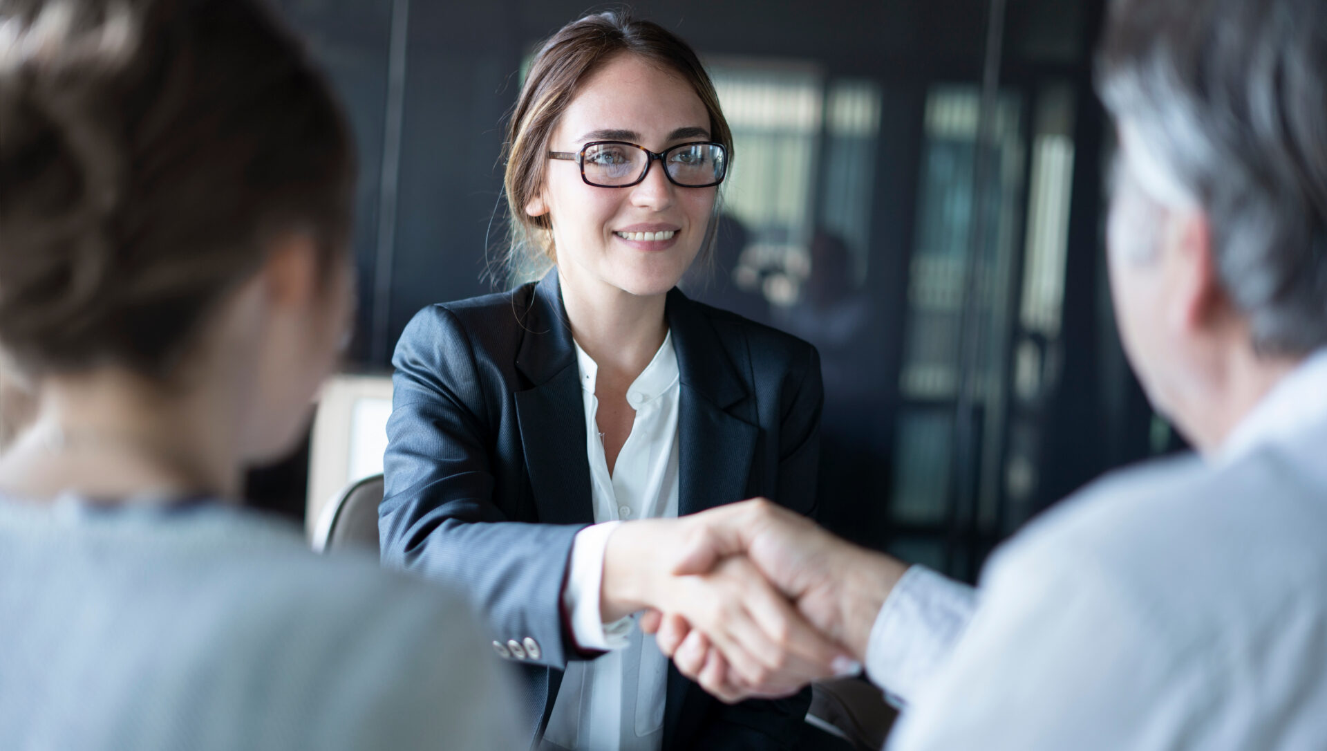 woman shaking hands with a quaint oak bank team member after opening an 18 month CD