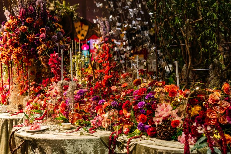 Ornate floral table display with vibrant flowers and cascading arrangements at the Philadelphia Flower and Garden Show